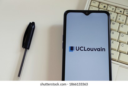 Bahia, Brazil - December 2, 2020. UCLouvain Logo On Smartphone Screen On Top Of Laptop. UCLouvain Is The Catholic University Of Louvain (Université Catholique De Louvain). 