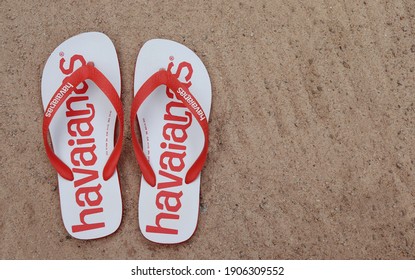 Bahia, Brazil - December 4, 2020: Brazilian Havaianas Flip Flops Sandals On Sandy Beach. Summer Concept.