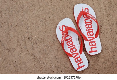 Bahia, Brazil - December 4, 2020. Brazilian Havaianas Flip Flops Sandals On Sandy Beach. Summer Concept.