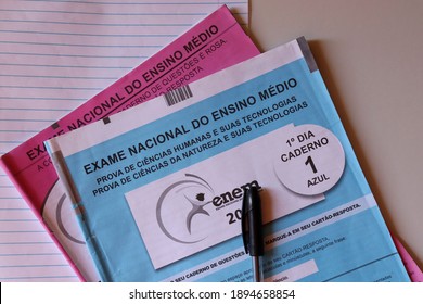 Bahia, Brazil. November 6, 2020: Text In Portuguese: Brazilian National High School Exam. | ENEM Tests On Top Of Notebook On White Table.