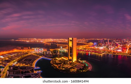 Bahrain Bay, Manama, Bahrain - December 27, 2019 : Arial Cityscape Night View Of Manama City, Diplomatic Area, Four Seasons Hotel, Arcapita, Al Baraka, Muharraq Bridge In Blue Hour With City Lights