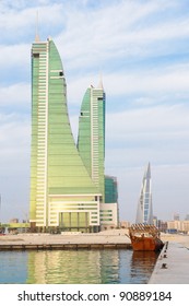 Bahrain Manama city view with Financial center and a dhow boat on foreground in a cloudy day