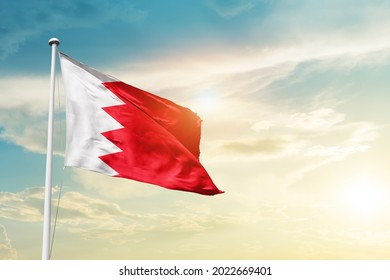 Bahrain national flag waving in beautiful clouds. - Shutterstock ID 2022669401