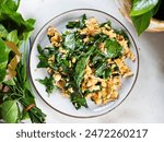 Bai Liang Pad Kai, stir fried Malindjo or Baegu leaves with egg, popular Thai southern dish