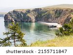 Baikal Lake on summer day. Tourists travel by motorboat along the Small Sea and stop in beautiful sandy bays on Olkhon Island on a sunny hot day. Summer seaside holidays concept. Natural background