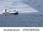 Baikal Lake at Spring. Top view of an all-terrain vehicle Hivus carrying passengers to Olkhon Island during the ice drift at April windy day. Natural background. Unusual travel