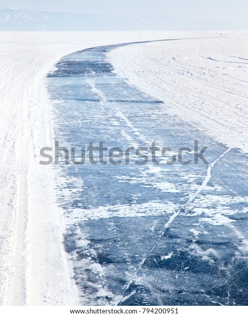 Baikal Lake in winter. Ice road on frozen lake\
Baikal. Winter tourism