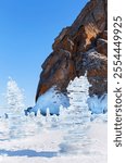 Baikal Lake in winter. Tourists traditionally build ice pyramids from transparent ice floes near the famous Cape Hoboy or Deva Rock on Olkhon Island. Winter travel and outdoor recreation