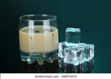 Baileys Liqueur In Glass On Blue Background