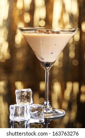 Baileys Liqueur In Glass On Golden Background