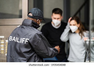 Bailiff Debt Collector At Door In Mask