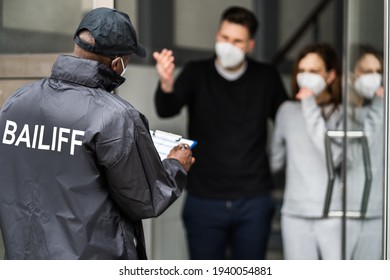 Bailiff Debt Collector At Door In Mask