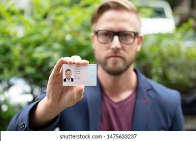 Bailiff Standing At House Entrance Showing Id