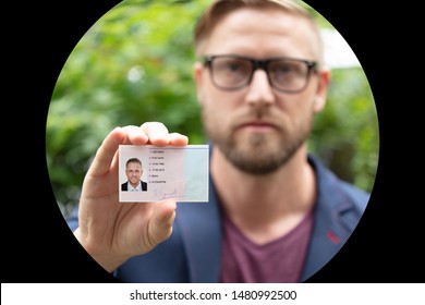 Bailiff Standing At House Entrance Showing Id
