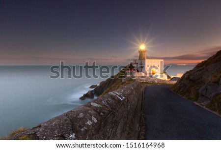 Similar – Leuchtturm an felsiger Küste am Meer