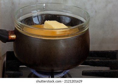 Bain-marie With Sugar, Butter And Honey In Glass Bowl On Saucepan As Ingredients Of Cake Medovik On Stovetop