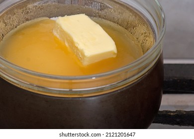 Bain-marie With Sugar, Butter And Honey In Glass Bowl On Saucepan As Ingredients Of Cake Medovik On Stovetop