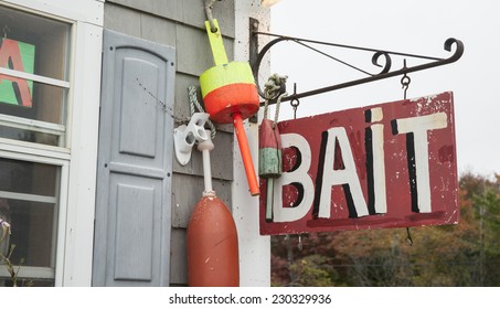 Bait Shop Sign Hang From Wall With Fishing Buoys.