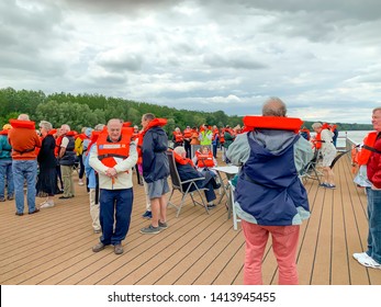 Baja, Hungary - May 23, 2019 :  Senior Tourists On River Cruise Participating In Safety Drill On Deck Of Ship.