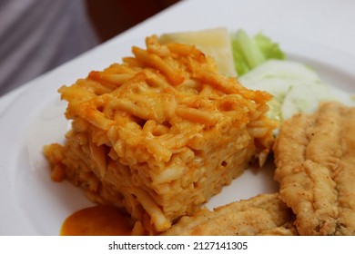 Bajan Macaroni Pie On A Plate With Fried Flying Fish