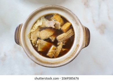 Bak Kut Teh with spareribs and fried tofu on white table background that Asia foods and Favor in Singapore - Top view.