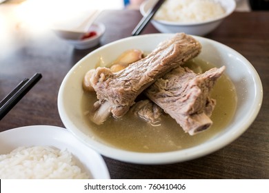 Bak Kut Teh in the white bowl with rice.  Bak Kut Teh is a pork rib dish cooked in broth popularly served in Malaysia and Singapore where there is a predominant Hoklo and Teochew community.