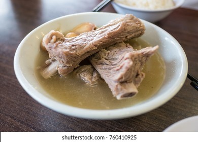 Bak Kut Teh in the white bowl.  Bak Kut Teh is a pork rib dish cooked in broth popularly served in Malaysia and Singapore where there is a predominant Hoklo and Teochew community.