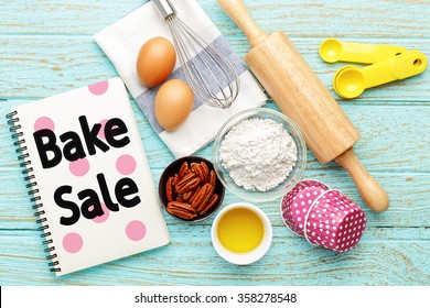 Bake Sale With Baking Ingredients On Wood Table