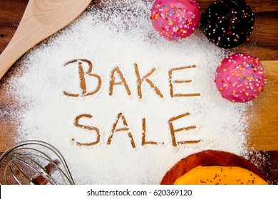 Bake Sale With Cake Written In Flour
