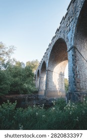 Bake Thin Viaduct spanning Bakethin Reservoir in Northumberland, captured with clear views of the stone arches and calm reflective water