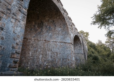 Bake Thin Viaduct spanning Bakethin Reservoir in Northumberland, captured with clear views of the stone arches and calm reflective water