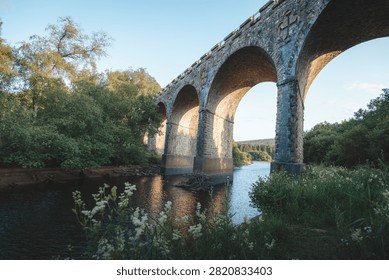 Bake Thin Viaduct spanning Bakethin Reservoir in Northumberland, captured with clear views of the stone arches and calm reflective water