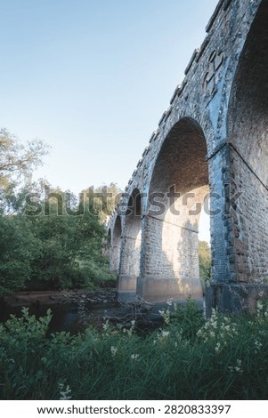 Bake Thin Viaduct spanning Bakethin Reservoir in Northumberland, captured with clear views of the stone arches and calm reflective water