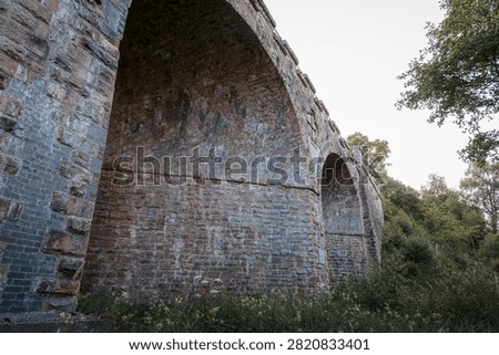 Bake Thin Viaduct spanning Bakethin Reservoir in Northumberland, captured with clear views of the stone arches and calm reflective water