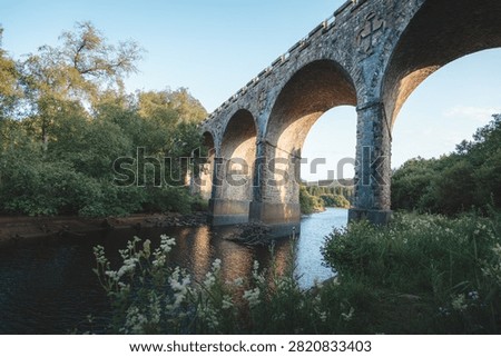 Bake Thin Viaduct spanning Bakethin Reservoir in Northumberland, captured with clear views of the stone arches and calm reflective water