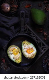 Baked Avocado With Egg On A Dark Background