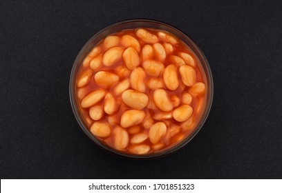 Baked Beans In Tomato Sauce Isolated On Black Background With Copy Space, Top View