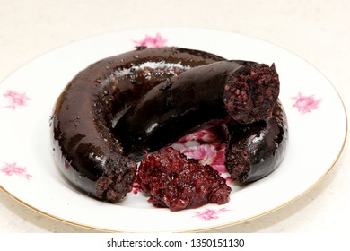 Baked blood sausage. blood sausage with jam on white plate