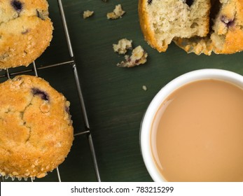 Baked Blueberry And Cranberry Muffins With A Mug Of Tea Or Coffee