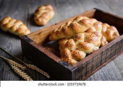 Baked braided bread rolls studded with red bell pepper, chili and chia seeds - Powered by Shutterstock