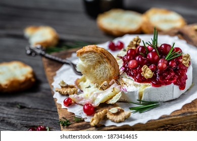 Baked Camembert Brie With Fresh Rosemary And Cranberry Sauce. Gourmet Appetizer. Breakfast, Food Recipe Background. Close Up