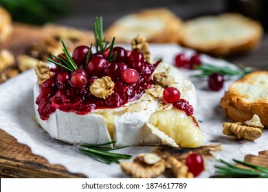 Baked Camembert Brie With Fresh Rosemary And Cranberry Sauce. Gourmet Appetizer. Breakfast, Food Recipe Background. Close Up