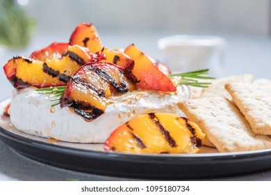 Baked Camembert cheese with grilled peach and rosemary - Powered by Shutterstock