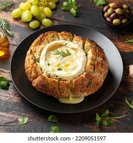 Baked Camembert Cheese In Sourdough Bread With Rosemary, Garlic, Thyme