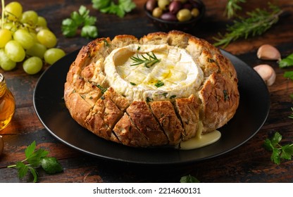 Baked Camembert Cheese In Sourdough Bread With Rosemary, Garlic, Thyme