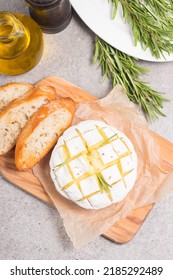 Baked Camembert Soft Cheese. Grilled Brie With Toasts And Rosemary. 