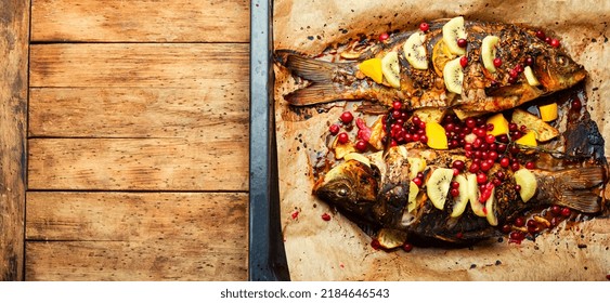 Baked Carp Fish With Cranberries, Kiwi And Mango On Baking Dish. Copy Space