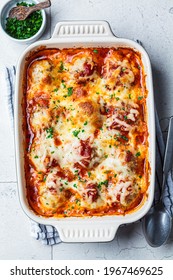 Baked Cheesy Meatballs Casserole With Tomato Sauce In The Oven Dish.