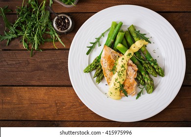 Baked Chicken Garnished With Asparagus And Herbs. Top View