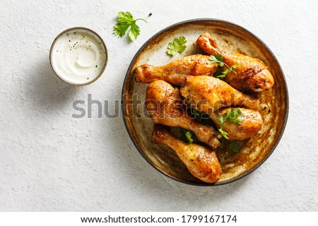 Baked chicken legs with spices and fresh herbs. Top view.